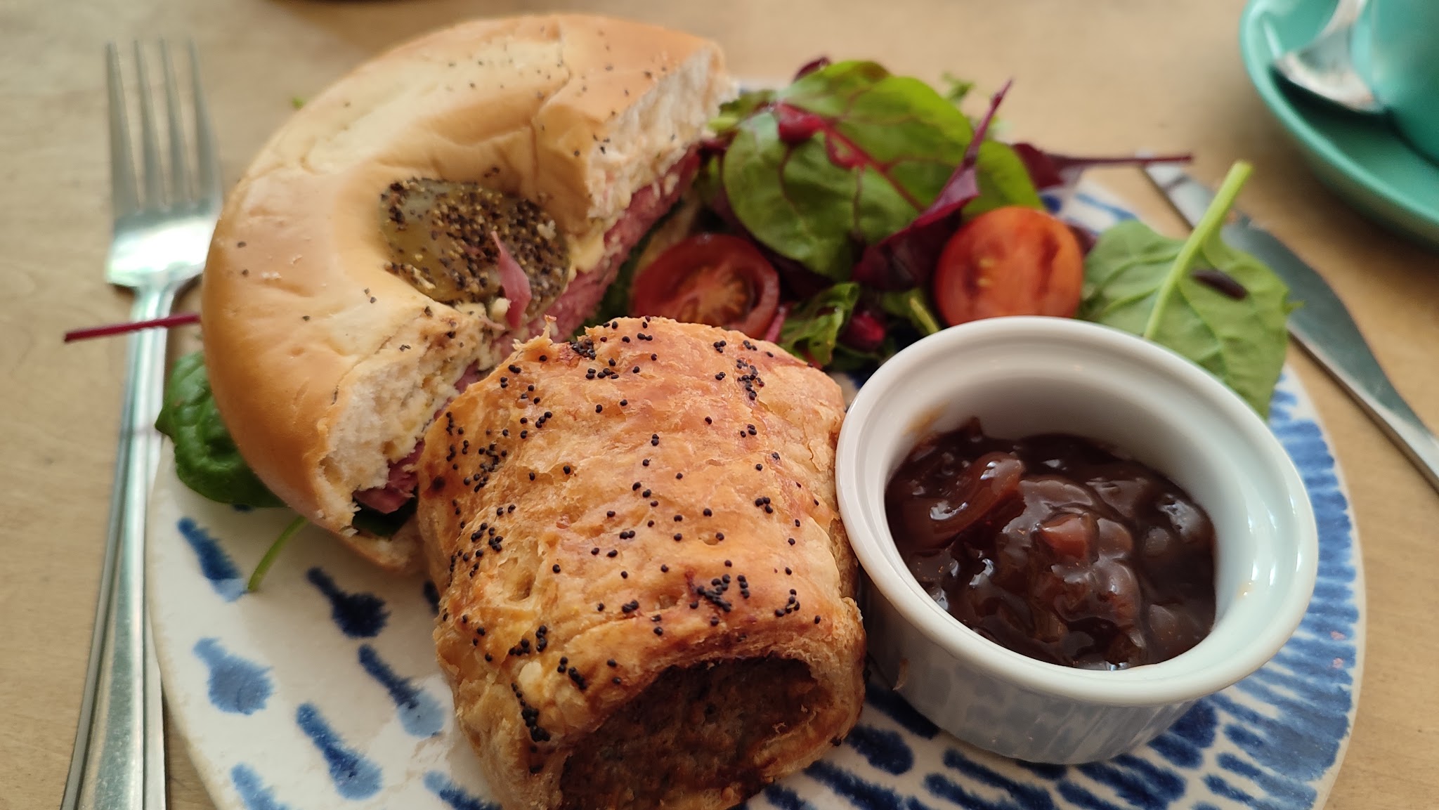A sandwich and savoury pastry served with salad